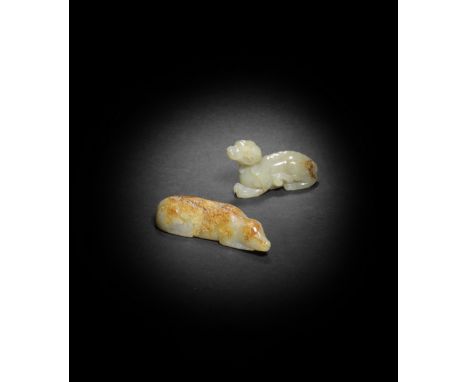 TWO PALE GREEN AND RUSSET JADE CARVINGS OF HOUNDSThe smaller smoothly carved recumbent with head tilted up with alertness, wi