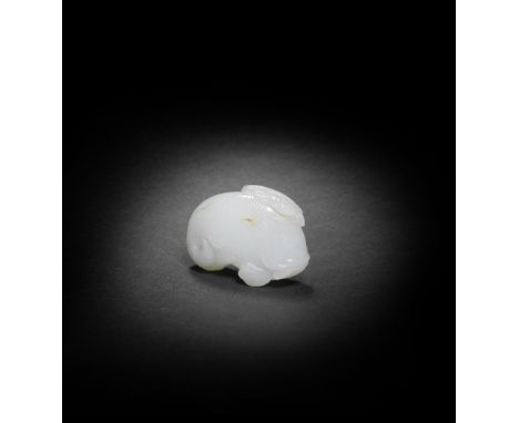 A WHITE JADE CARVING OF A FISH AND LOTUS19th/20th centuryThe pebble smoothly carved as a scaly fish clasping in its mouth a s