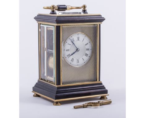 A French brass and ebonised carriage clock, silvered dial, signed F.G. RUSSELL, MALVERN, within an engine-turned facing, plat