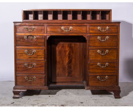 A George III mahogany desk, super structure with nine pigeon holes, tooled leather surface, sloping and supported on a ratche