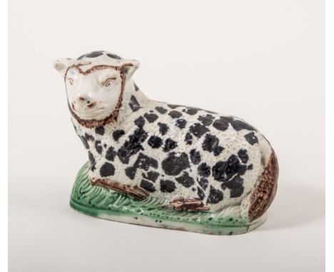 A Pearlware hollow-base model of a recumbent ewe, Staffordshire or Yorkshire, circa 1800, 10cm.