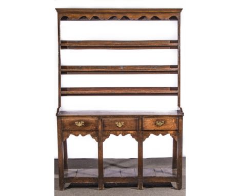 A Joined oak dresser, basically early 19th century, three shelf delft rack, under a moulded canopy piece, boarded top with th