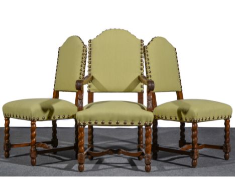 A set of sixteen Dutch style oak dining chairs, 20th Century, arched backs with close studded cotton and part floral tapestry