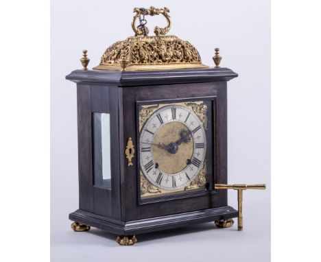 A Charles II style ebony and ebonised bracket clock, gilt metal 'casing' and  'basket' top, with seraphim swags and foliage, 