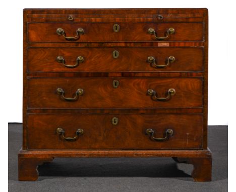 A George III mahogany chest of drawers, rectangular top with a moulded edge, fitted with a brushing slide over four graduatin