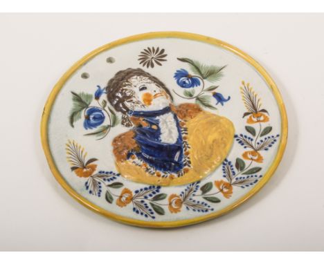 A Prattware circular portrait plaque, The Prince Regent, circa 1810, the background delicately painted with flowers, pierced 