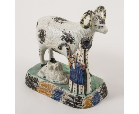 A Prattware, ram and shepherdess group, Yorkshire 1800-1820, the shepherdess tipping her hat and carrying a basket, model wit