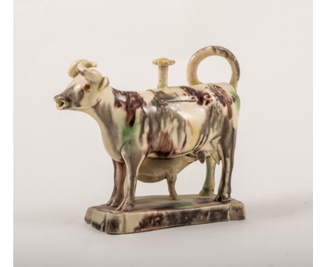 A Staffordshire creamy earthenware cow and calf creamer, Whieldon type, late 18th century, with a flower head finial to the l