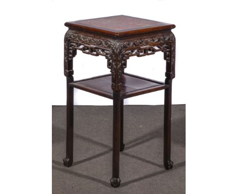 A Chinese carved hardwood stand, square shaped top with a marble inset, foliate and scroll frieze with fretwork, fitted with 