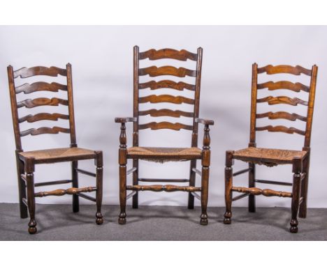 A set of eight Lancashire-type ladder-back chairs, 20th century, rush seats, turned legs joined by rails, comprising two elbo