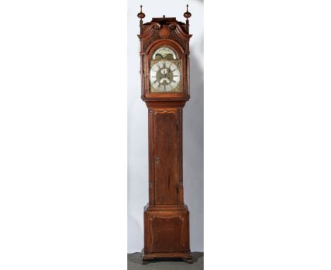 Baddley, TongAn oak and mahogany long case clock, the hood with turned finials, carved scrolls, and open fretwork, turned col