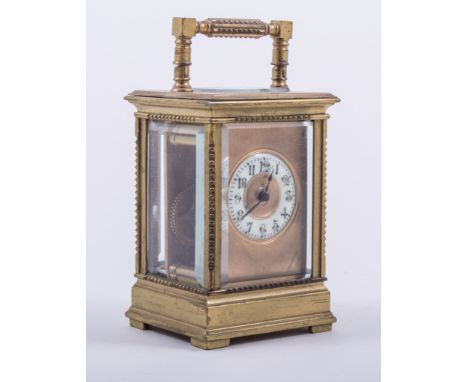 A small French brass cased carriage clock, white enamel chapter ring with Arabic numerals, platform escapement, 10cm, in a Mo