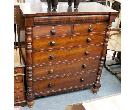 A Victorian Mahogany Scotch Chest, with concealed drawer to the barrel frieze, having rosewood drawer pulls, turned baluster 