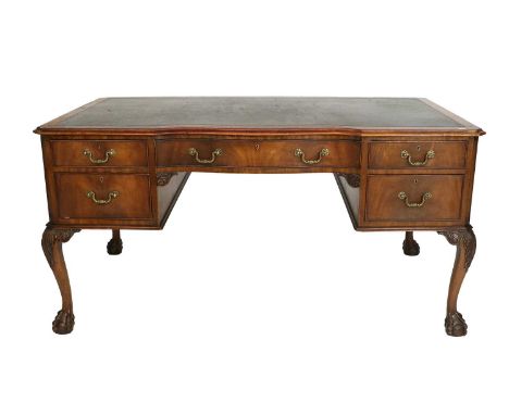 An Early 20th Century Mahogany Chippendale-Style Writing Table, the moulded top with canted corners and a green leather writi