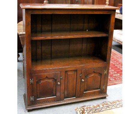 A Titchmarsh &amp; Goodwin Style Oak Open Bookcase, on two door cupboard base, 95cm by 29cm by 106cmBottom shelf - 29cm highT