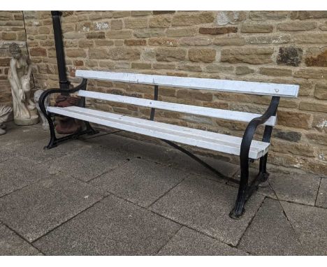 A 19th Century Wooden Slated Cast Iron Garden Bench, possibly by Charles Wicksteed, with scroll formed ends and painted slats