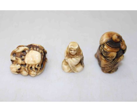 Three Japanese Meiji period ivory netsuke, one with crab and frogs signed.