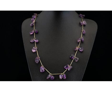 A Vintage Amethyst Necklace Long pewter tone necklace set with multiple, organic form polished amethyst stones between elonga