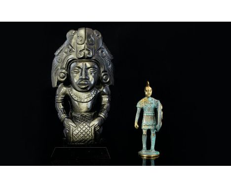 A Carved Hematite Figure In the form of a Mayan deity, 10 inches in height. Along with an archaic style brass figure in the f