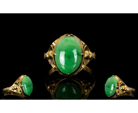 Chinese 18ct Gold Top Quality Single Stone Jade Ring, The Oval Shaped Jade of Excellent Quality, Natural Colour. Marked 18ct.