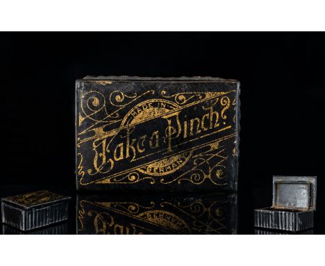 A Late 19th/Early 20th Century Black Papier Mache Snuff Box Of rectangular form, the hinged lid bearing gilt inscription 'Tak