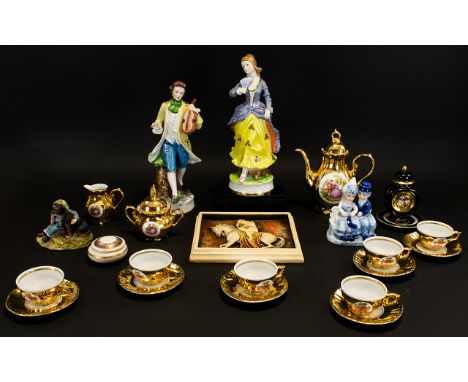 A Small Box Of Ceramics And Figures A varied collection to include gilt trim tea set, Ivorex Lady Godiva plaque, a pair of co