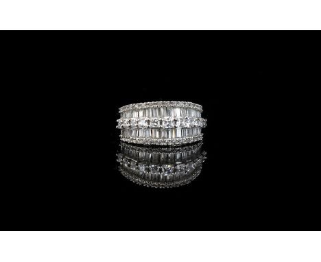 A CZ And Platinum Plated Silver Dress Ring Art Deco style statement ring set with three rows of step cut CZ stones, the whole