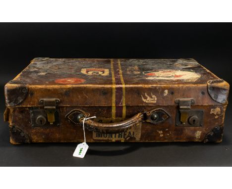 A Vintage Suitcase Brown leather top handle travel case with protective brass corners and locking mechanism, wonderful aged p