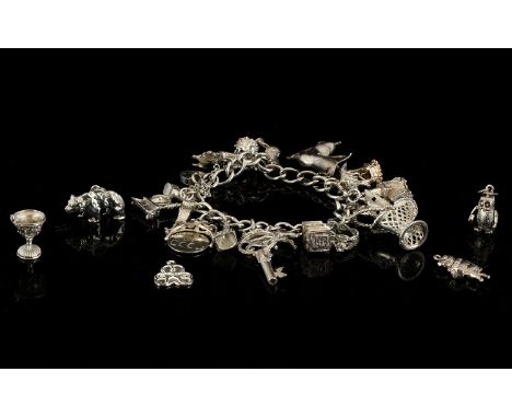 A Vintage Silver Curb Bracelet - Loaded with 25 Silver Charms. All Interesting and Well Made Charms and Marked for Silver. Pl
