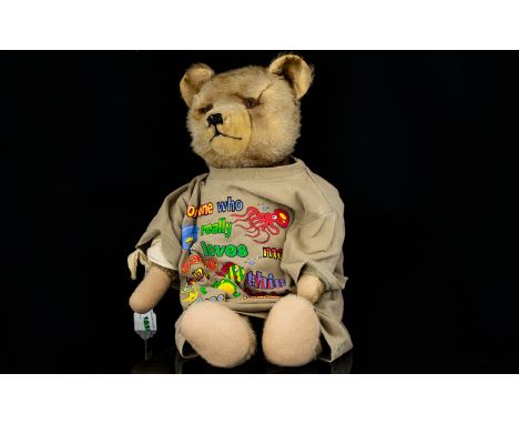 Well-loved vintage Growler Teddy Bear with moveable arms, head and legs, glass eyes, some damage to right arm.  Lovely face t