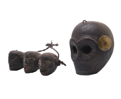 North East India, Naga, a wooden monkey head, decorated with two circular brass discs. Herewith a wooden ornament of three ca