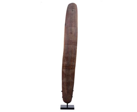 Western Austalia, Aboriginal, a wooden shield with carved geometrical patterns. L. 72 cm. on a stand. Provenance: Marc Johnso