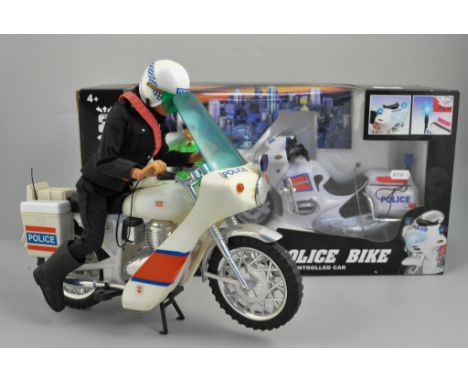 Action Man Police Patrol Officer and motor cycle, plus three other boxed toys.