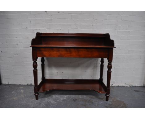 Victorian mahogany wash stand, top with a three quarter gallery rounded corners and a moulded edge, plain frieze, turned legs
