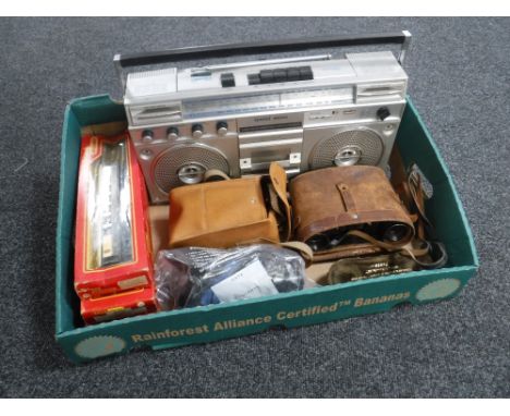 A box of Hornby Triang rolling stock, radio cassette recorder, cased Busch field glasses, camera etc 