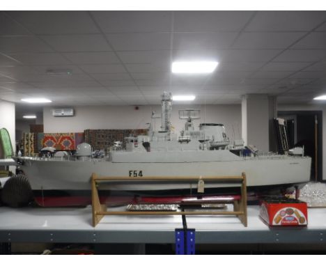 A remote controlled model boat - HMS Amazon on wooden stand (no hand set) CONDITION REPORT: The boat is 187cm long and 70cm h