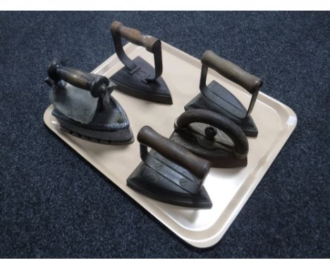 A tray of five vintage irons