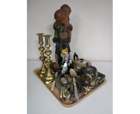 A tray of early twentieth century chalk figure, plated tea service, pair of brass candlesticks, assorted table cutlery etc 