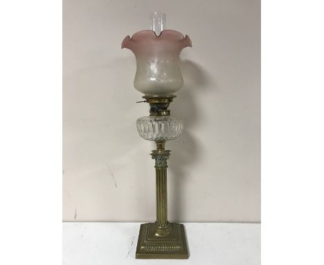 A Victorian glass oil lamp with clear glass reservoir CONDITION REPORT: Shade with numerous typical nicks to the lower rim. R