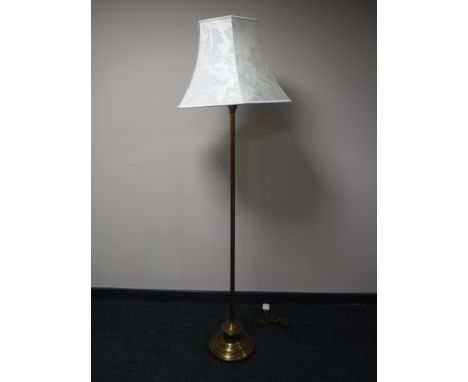 A brass Corinthian column standard lamp with shade 