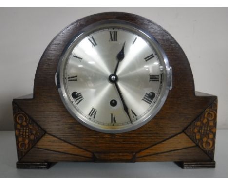 An oak Westminster chiming mantle clock with pendulum and key