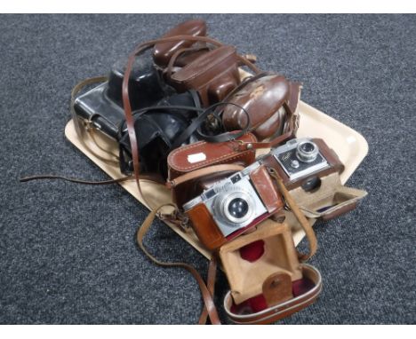 A tray of eight vintage cameras in leather cases including Paxette Zennit etc 