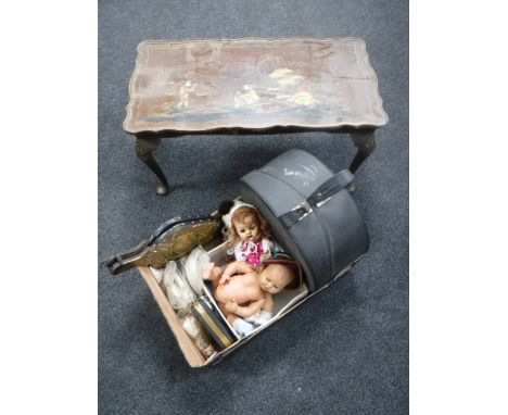 A walnut Oriental style coffee table together with a box of vintage dolls, hat box with hat, brass bellows etc 