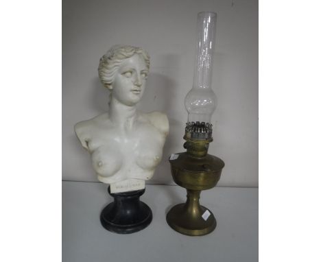 A brass Aladdin oil lamp with glass chimney together with a resin bust of Venus on stand