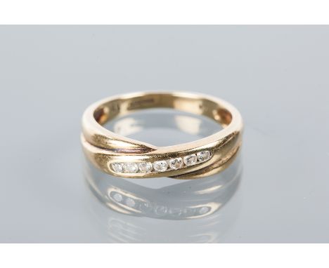 DIAMOND HALF ETERNITY RING
of crossover design, channel set with diamonds, hallmarked for nine carat gold, size M