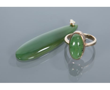 JADE PENDANT
set with a pear shaped section of darker green jade; along with a jade set ring (2)