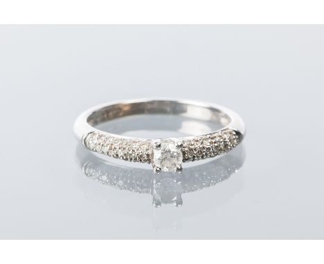 DIAMOND SOLITAIRE RING
the central brilliant cut diamond approximately 0.13 carats, on pave set diamond shoulders, marked 9ct