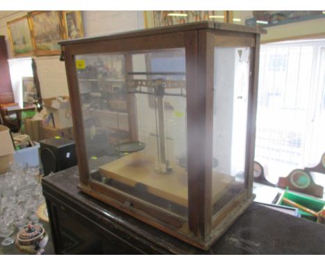 A glazed wooden cased chemist's scales 