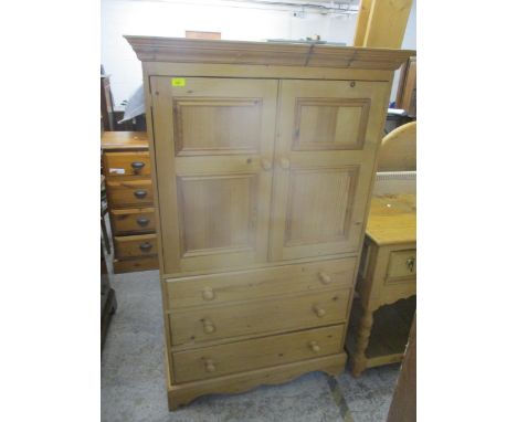 A contemporary pine side chest, twin cupboard door over three graduated drawers on bracket feet, 156cm x 95cm x 47.5cm, along