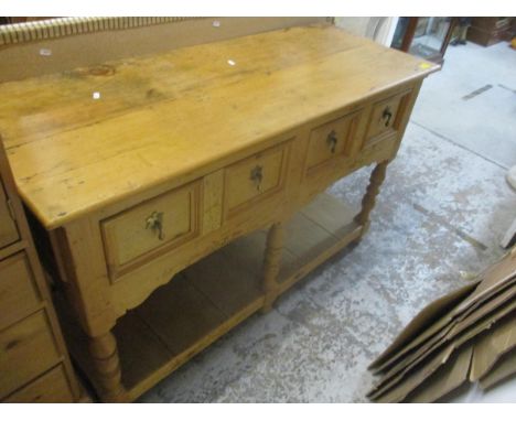 A pine two drawer dresser with pot shelf undertier, supported on turned columns and ball fee, 84cm x 134cm x 51.5cmLocation: 